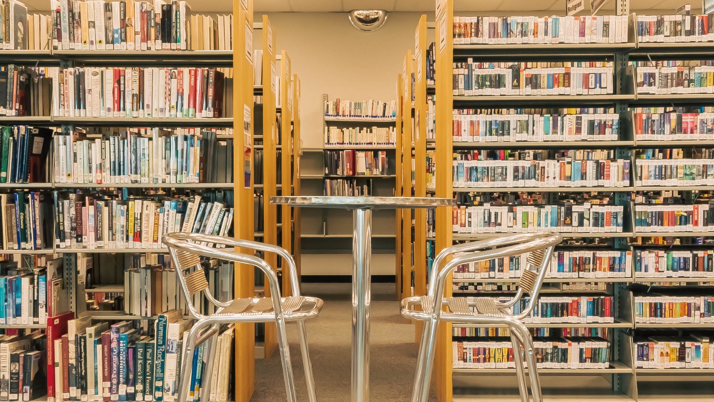 Table and chairs in front of bookshelves